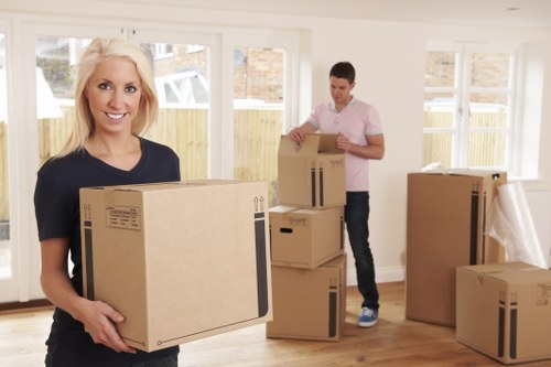 Packed moving boxes and household items ready for transport in Northolt