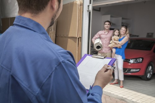 Professional packers organising household boxes in a Northolt home
