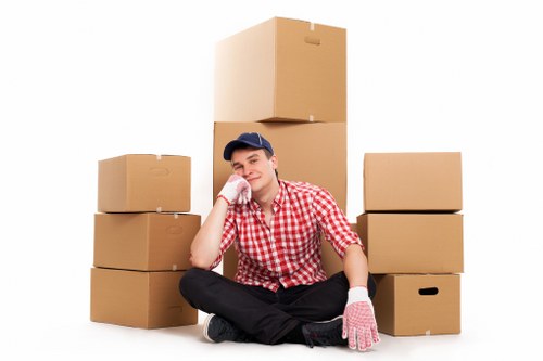 Packed boxes and furniture being loaded into a removal truck